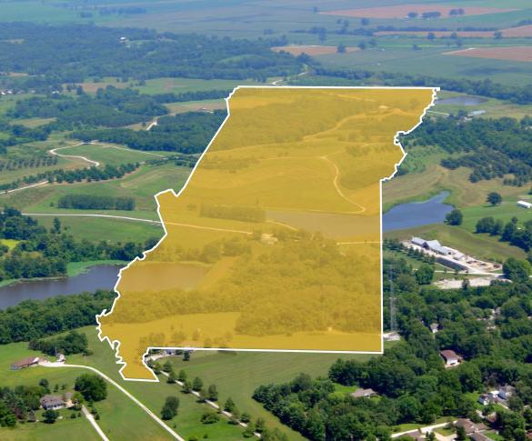 Missouri state outline over aerial photograph of Missouri fields and towns